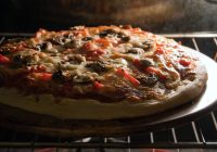 a-fresh-homemade-mushroom-and-pepper-pizza-fresh-out-of-the-oven-and-ready-to-slice-shallow-depth-of-field